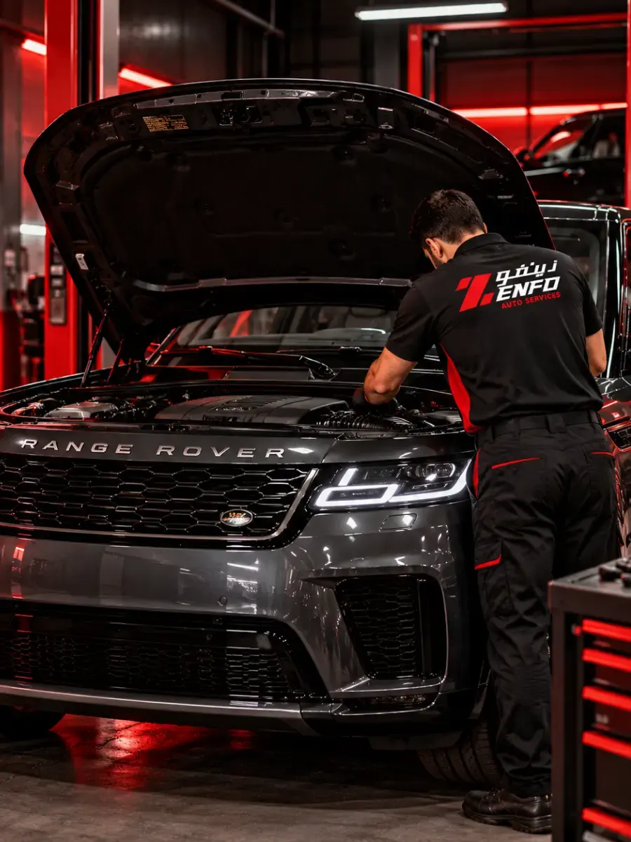 Zenfo technician working under the bonnet of a Range Rover at the Musaffah M9 workshop